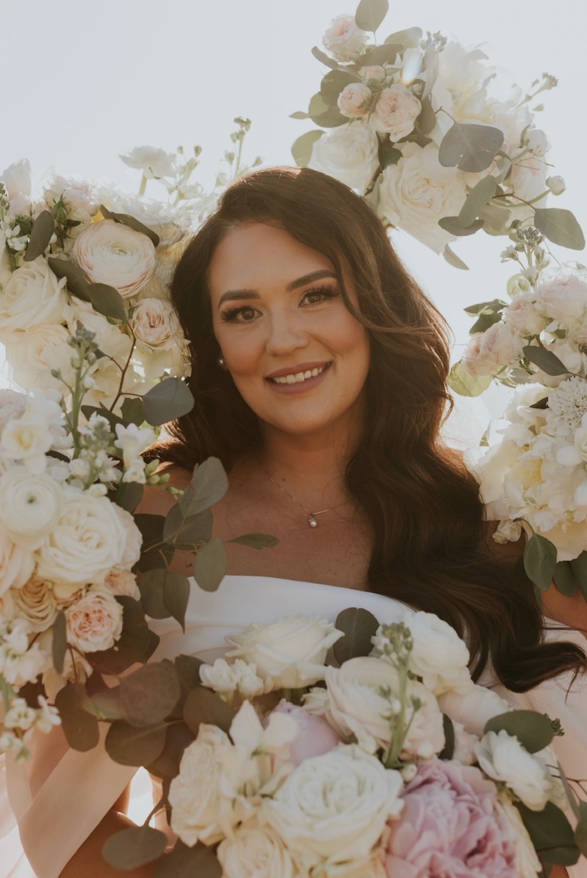 Jamie arranging a lush, garden-inspired bouquet in warm natural light
